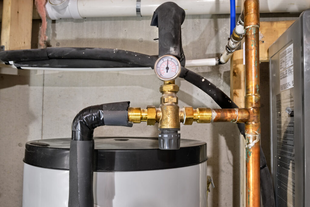 Technician performing routine maintenance on a residential tankless water heater system