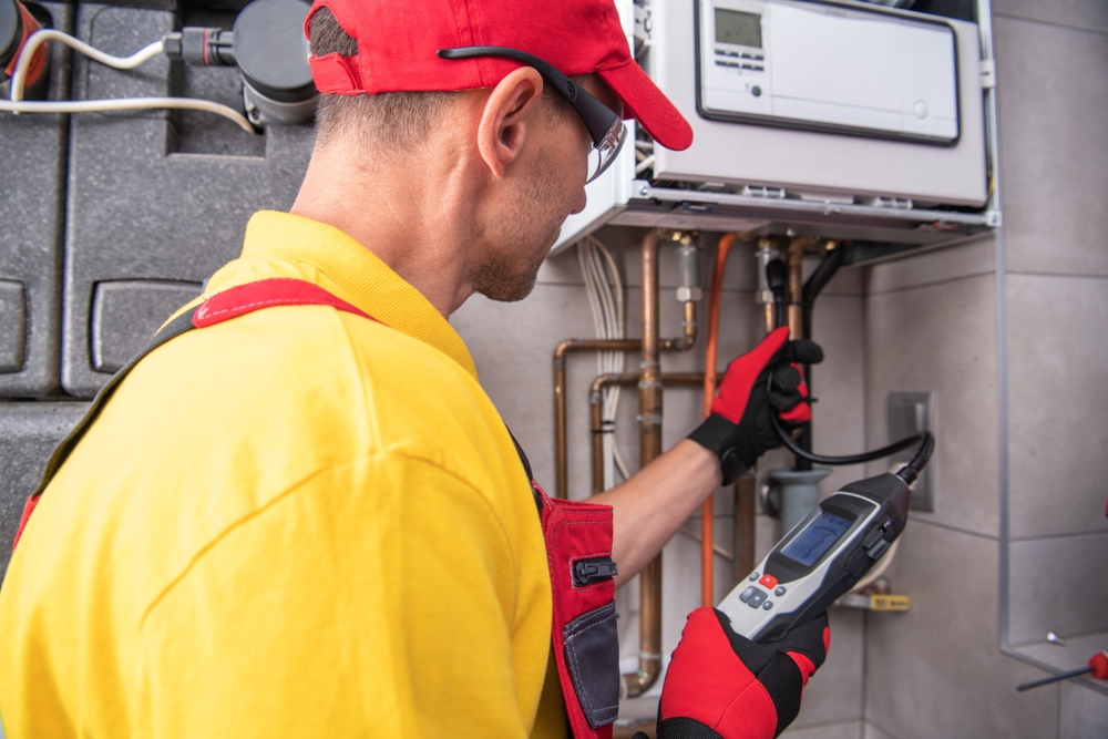 Home inspector checking plumbing system under sink during a pre-purchase home inspection
