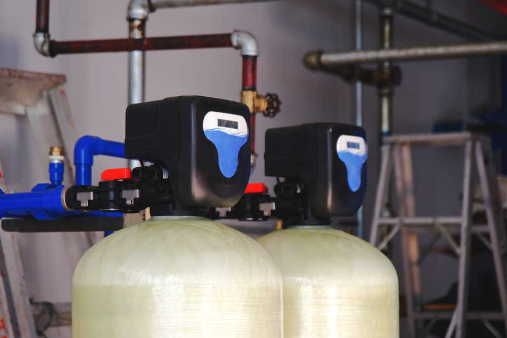Comparison of water softener and water filtration systems installed in a residential home utility area
