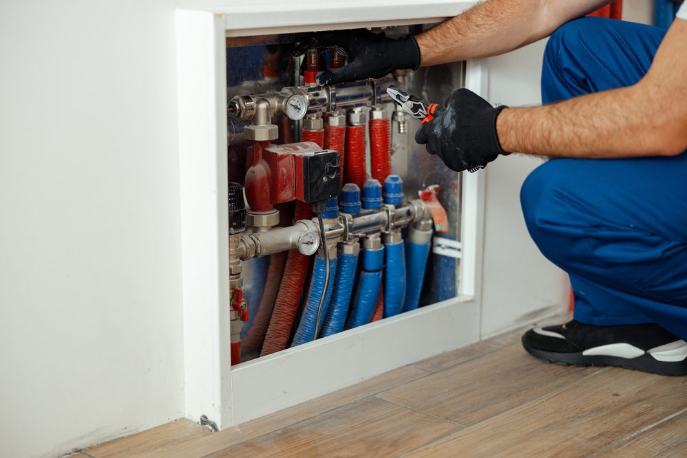 Plumber repairing small pipe problems before they turn into expensive home repairs